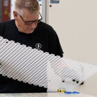 An employee works on a prototype of an electric battery at Lion Electric Company's lithium-ion battery manufacturing facility in Mirabel, Que., Thursday, Sept. 14, 2023.